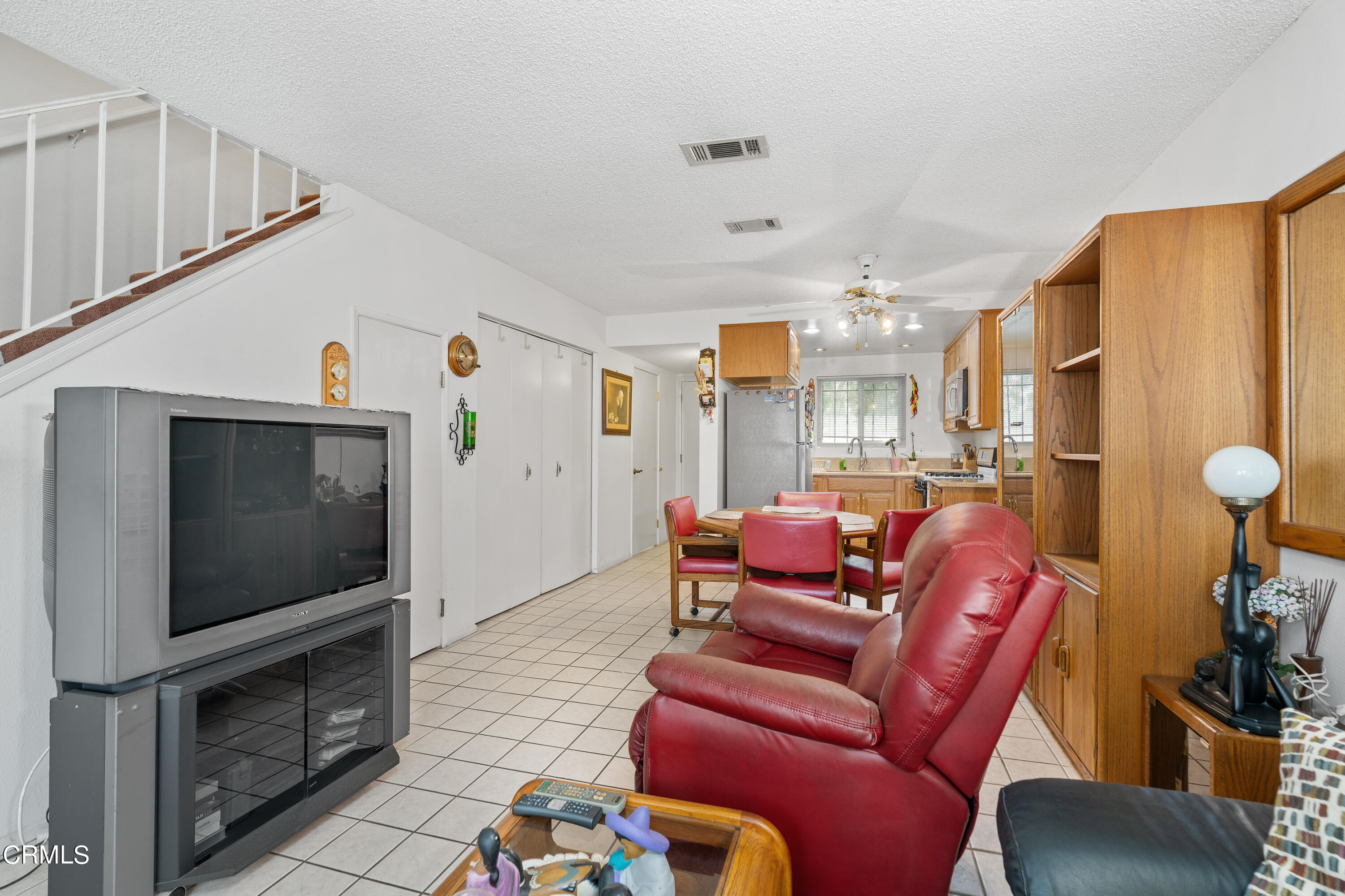 5170 North River Road, Unit C Oceanside, CA 92057 - Photo 9 of 43 a living room with furniture and a flat screen tv