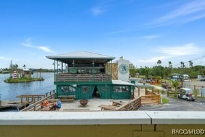 5291 South Cherokee Way Homosassa, FL 34448 - Photo 18 of 27 a view of a lake with couches chairs and a table