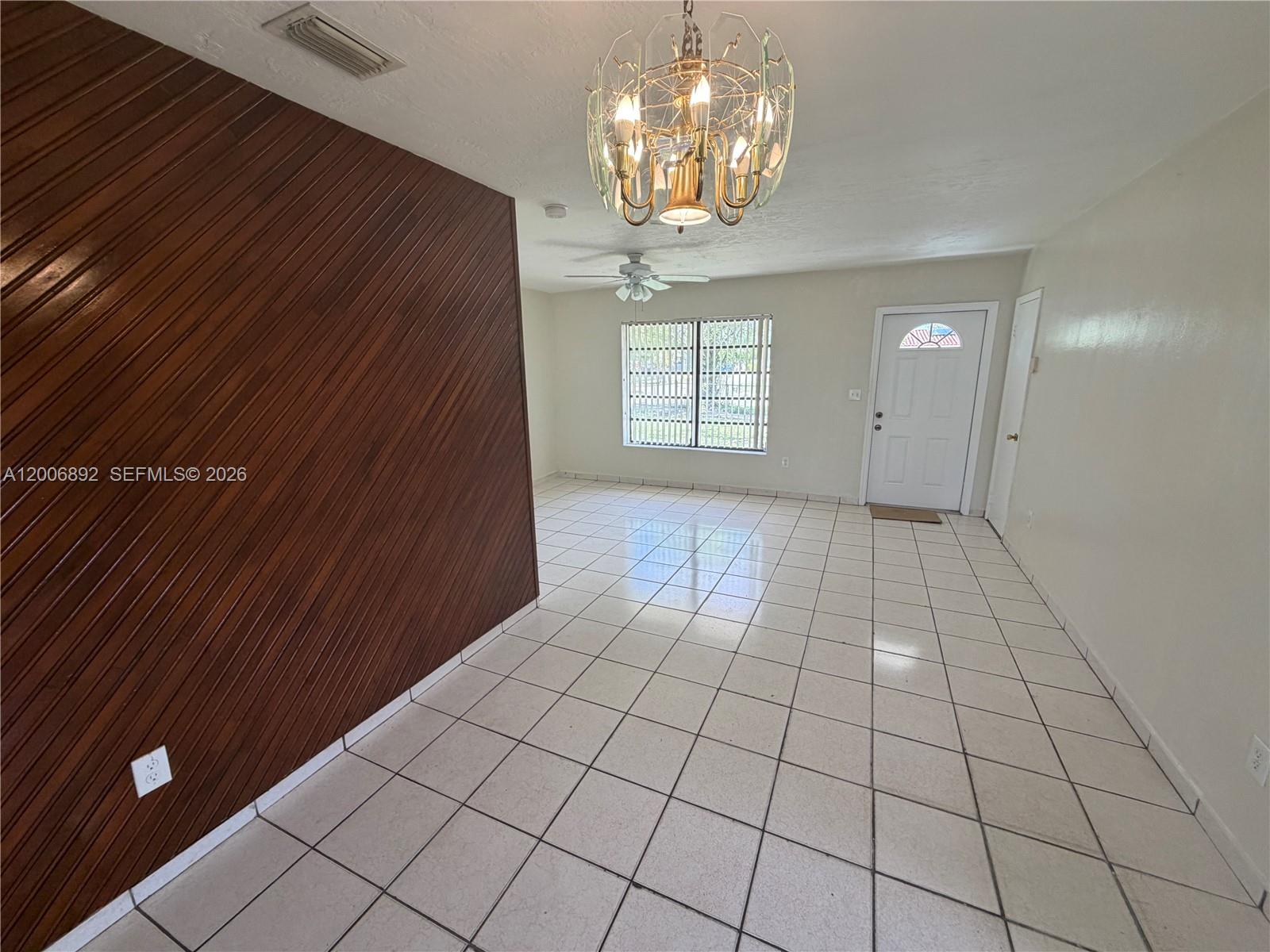 10375 Southwest 152nd Terrace Miami, FL 33157 - Photo 20 of 59 a view of an empty room with a chandelier