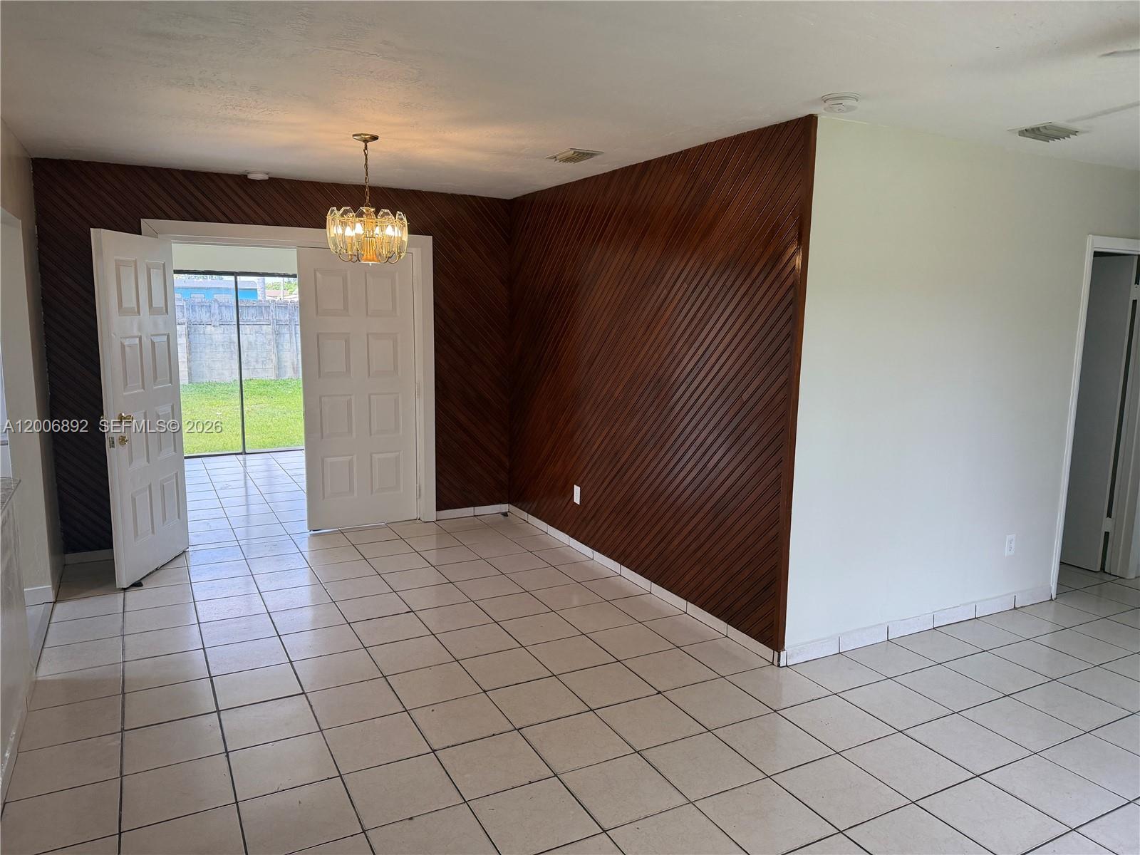 10375 Southwest 152nd Terrace Miami, FL 33157 - Photo 23 of 59 an empty room with kitchen view and wooden floor