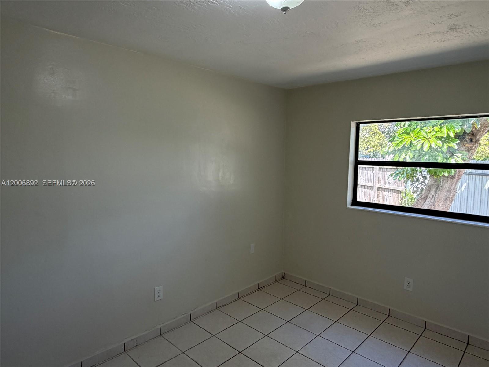 10375 Southwest 152nd Terrace Miami, FL 33157 - Photo 36 of 59 an empty room with a window