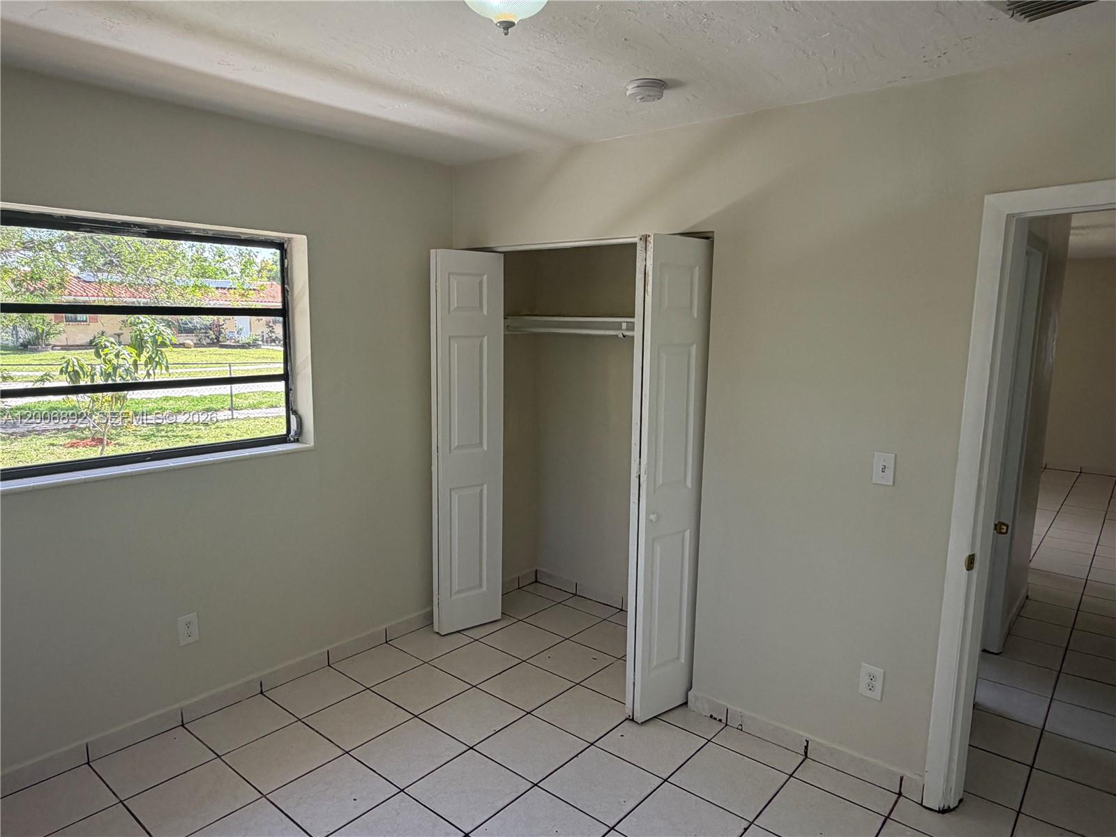 10375 Southwest 152nd Terrace Miami, FL 33157 - Photo 38 of 59 a view of an empty room with window