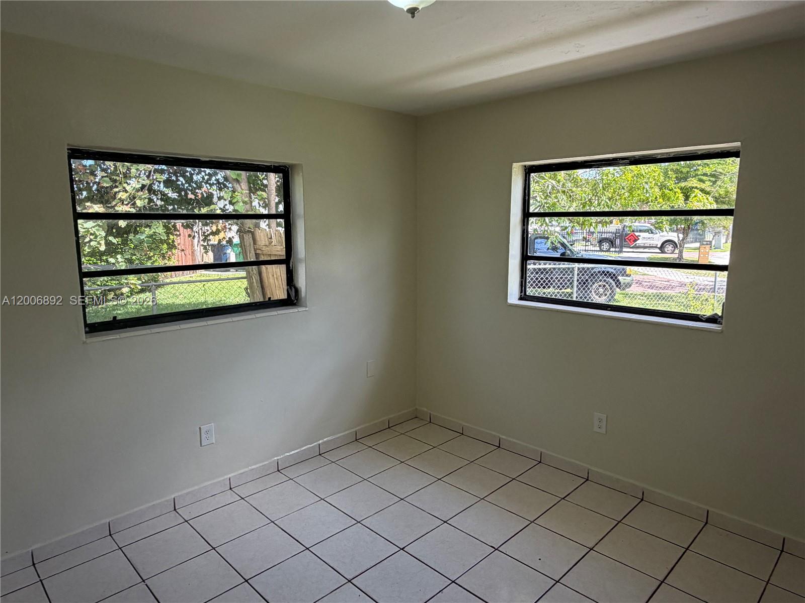 10375 Southwest 152nd Terrace Miami, FL 33157 - Photo 39 of 59 an empty room with windows