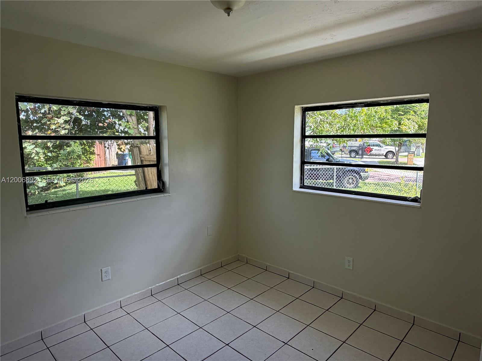 10375 Southwest 152nd Terrace Miami, FL 33157 - Photo 40 of 59 an empty room with windows