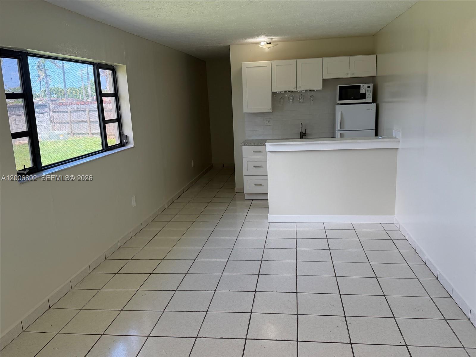 10375 Southwest 152nd Terrace Miami, FL 33157 - Photo 44 of 59 a kitchen with a sink a stove and cabinets