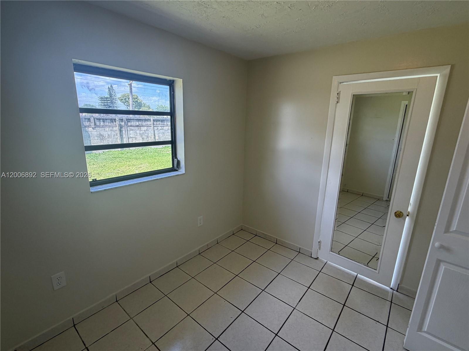 10375 Southwest 152nd Terrace Miami, FL 33157 - Photo 49 of 59 an empty room with windows