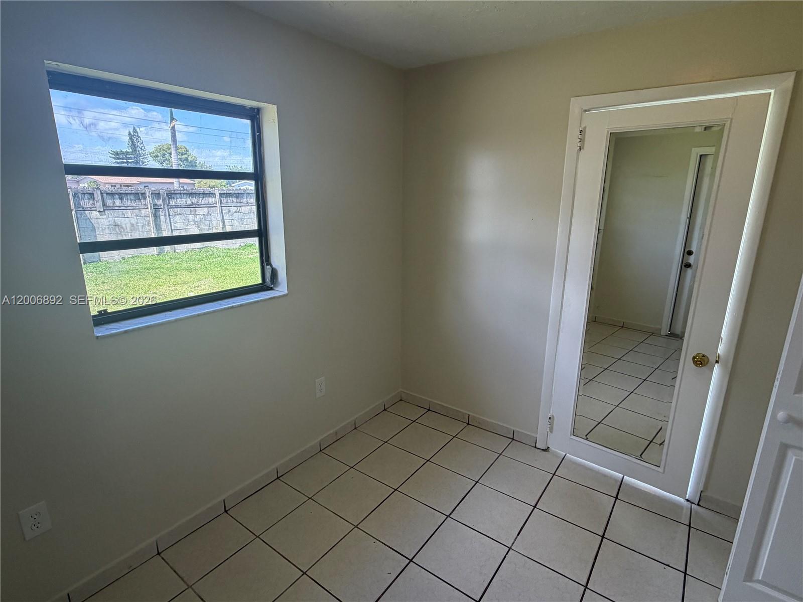 10375 Southwest 152nd Terrace Miami, FL 33157 - Photo 50 of 59 an empty room with windows