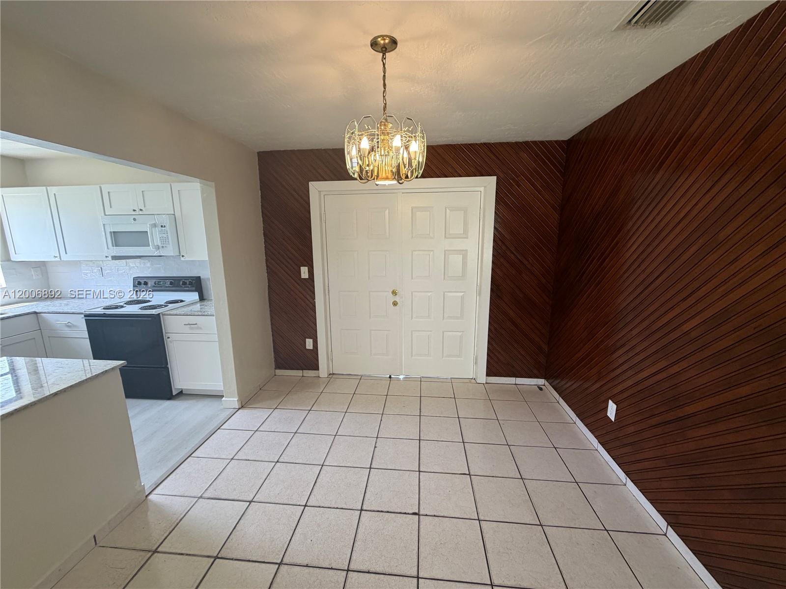 10375 Southwest 152nd Terrace Miami, FL 33157 - Photo 8 of 59 a view of an empty room with kitchen and window