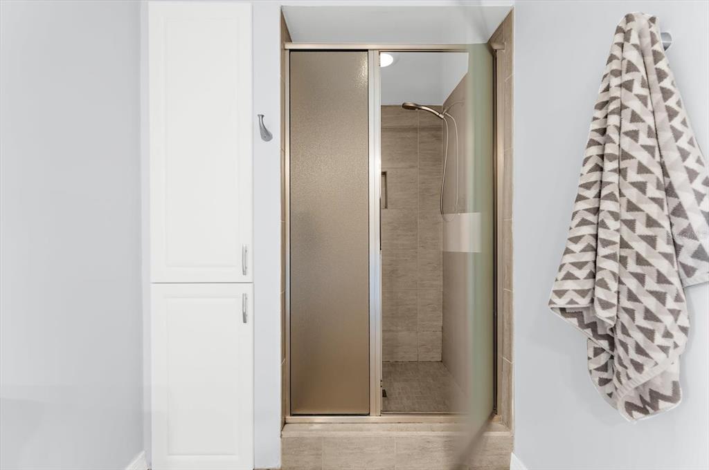 5 Barbados Road, Unit 31 Englewood, FL 34223 - Photo 19 of 40 a bathroom with a shower and a glass door