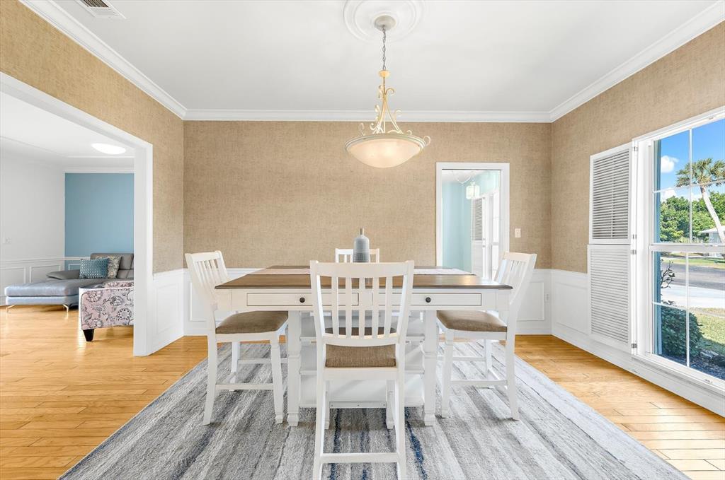 5 Barbados Road, Unit 31 Englewood, FL 34223 - Photo 4 of 40 a view of a dining room with furniture a chandelier and wooden floor