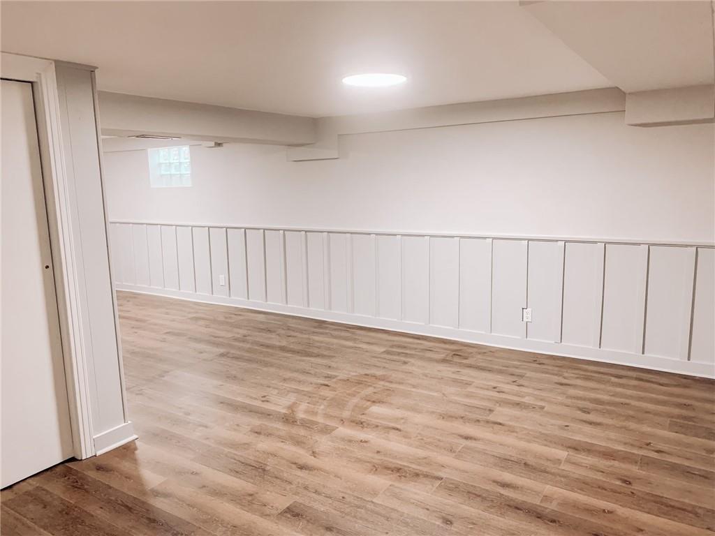 604 New Texas Road Pittsburgh, PA 15239 - Photo 11 of 18 a view of an empty room with wooden floor