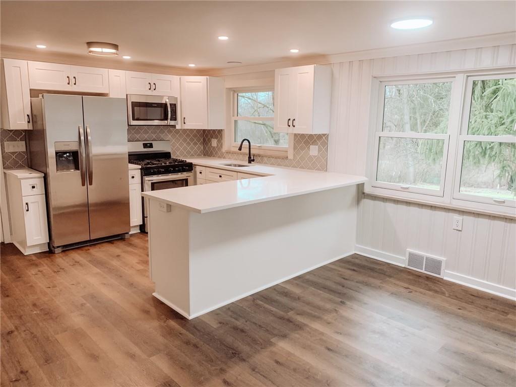 604 New Texas Road Pittsburgh, PA 15239 - Photo 2 of 18 a kitchen with stainless steel appliances a microwave a sink and a refrigerator