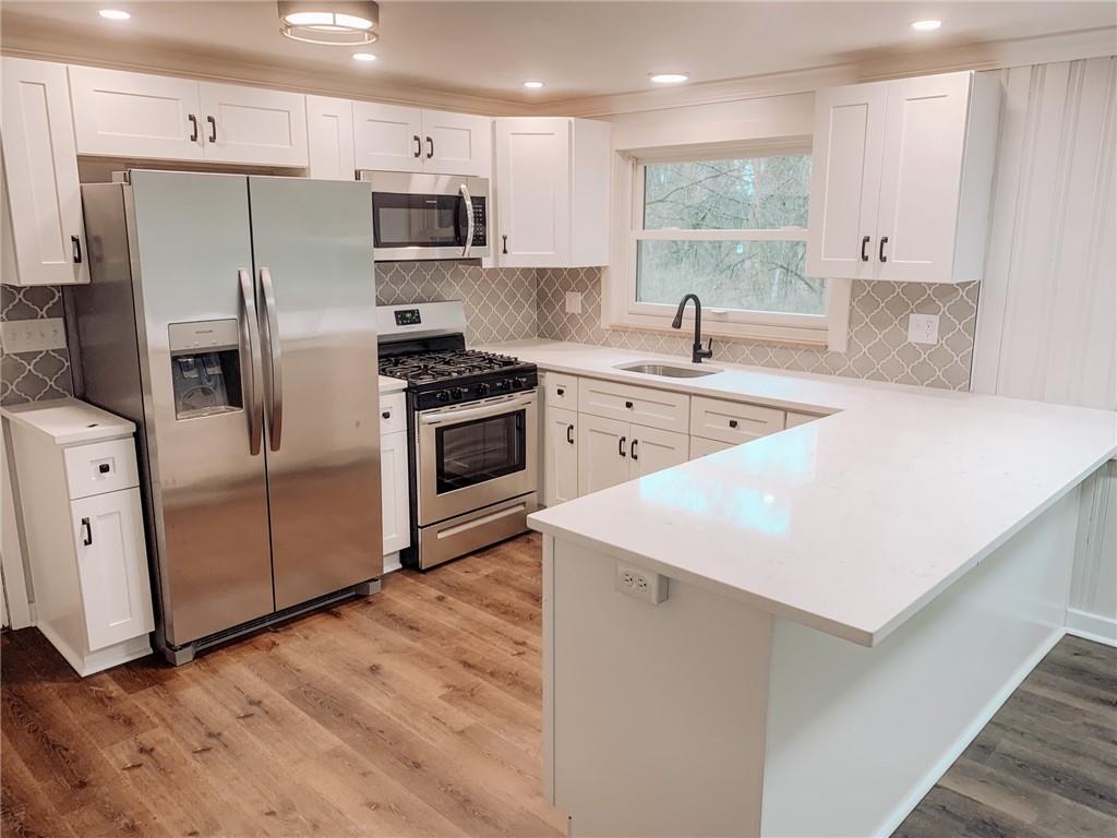 604 New Texas Road Pittsburgh, PA 15239 - Photo 3 of 18 a kitchen with stainless steel appliances white cabinets a sink and a stove