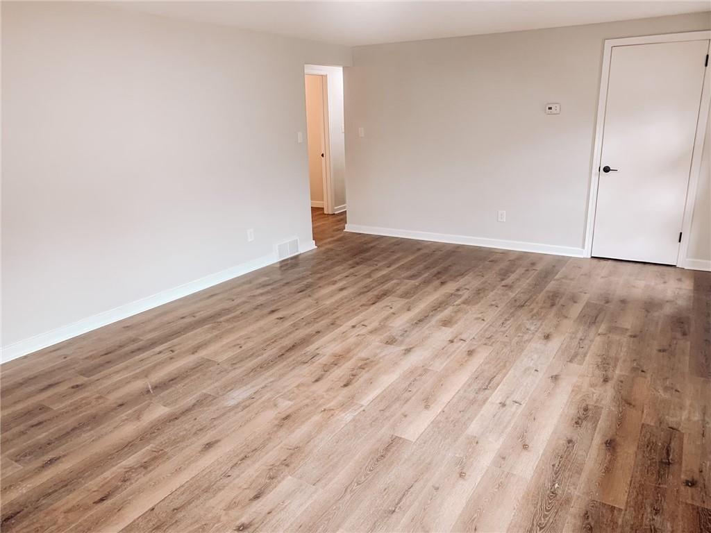 604 New Texas Road Pittsburgh, PA 15239 - Photo 6 of 18 a view of empty room with wooden floor