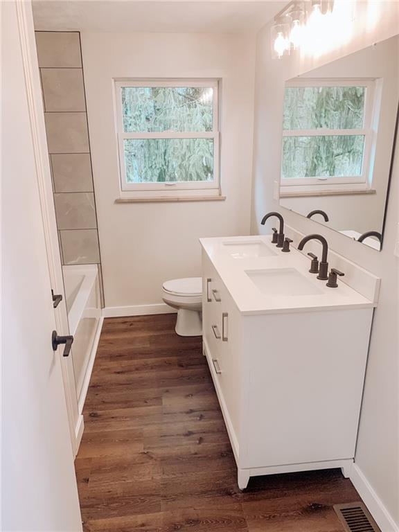 604 New Texas Road Pittsburgh, PA 15239 - Photo 8 of 18 a view of a bathroom with a sink and a window