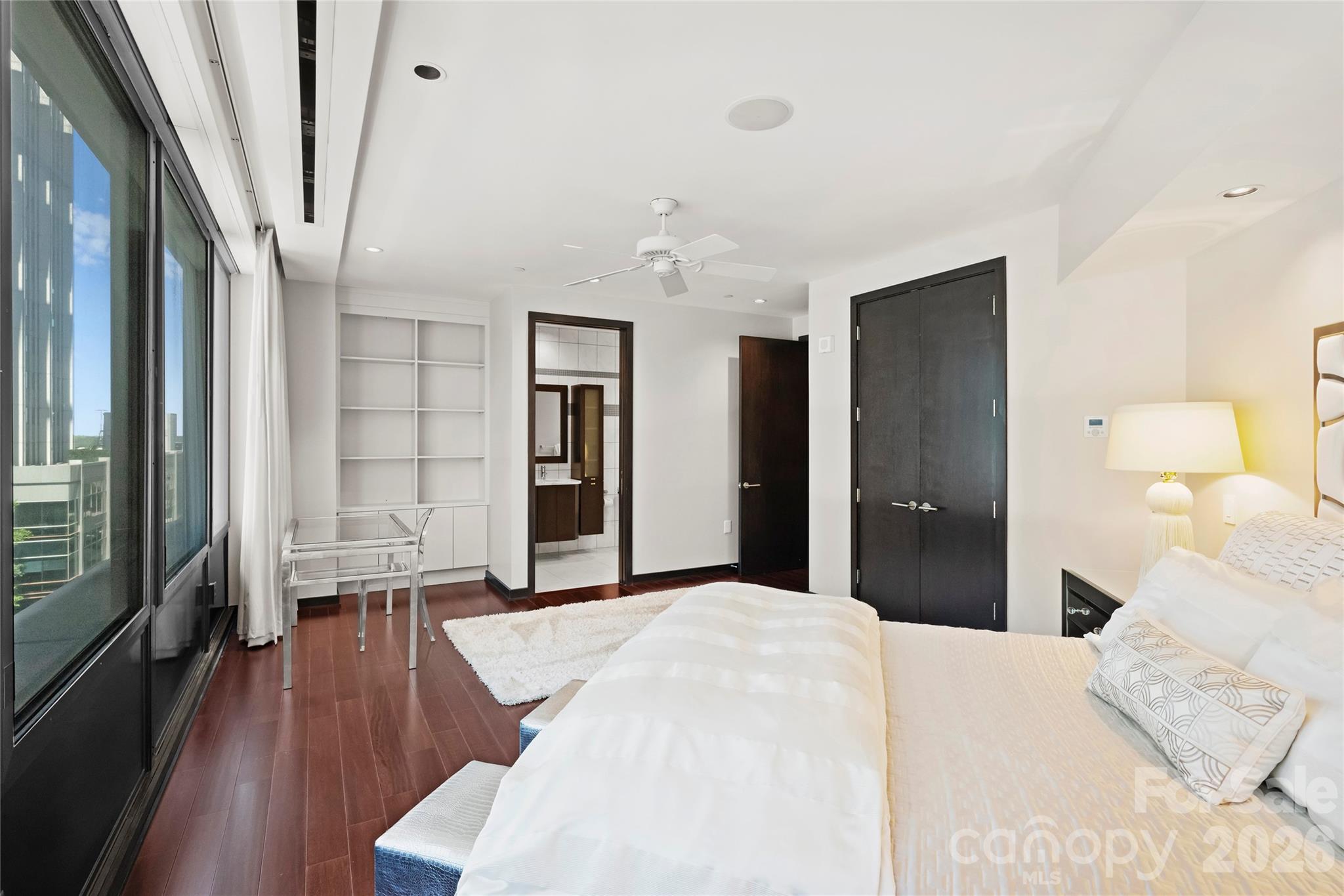 139 South Tryon Street, Unit 6 Charlotte, NC 28202 - Photo 37 of 47 a bedroom with a bed and wooden floor