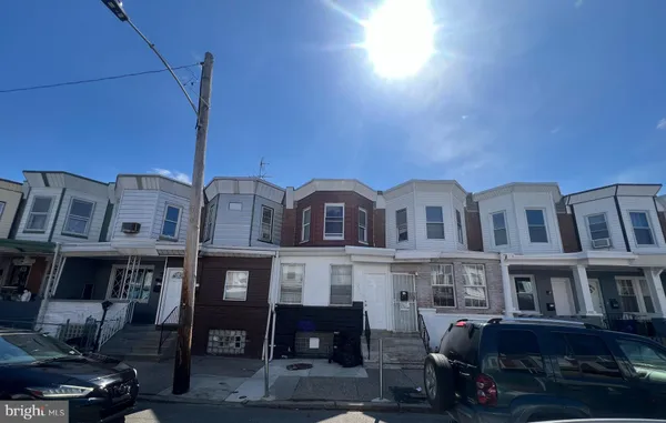 a front view of a residential apartment building with a yard