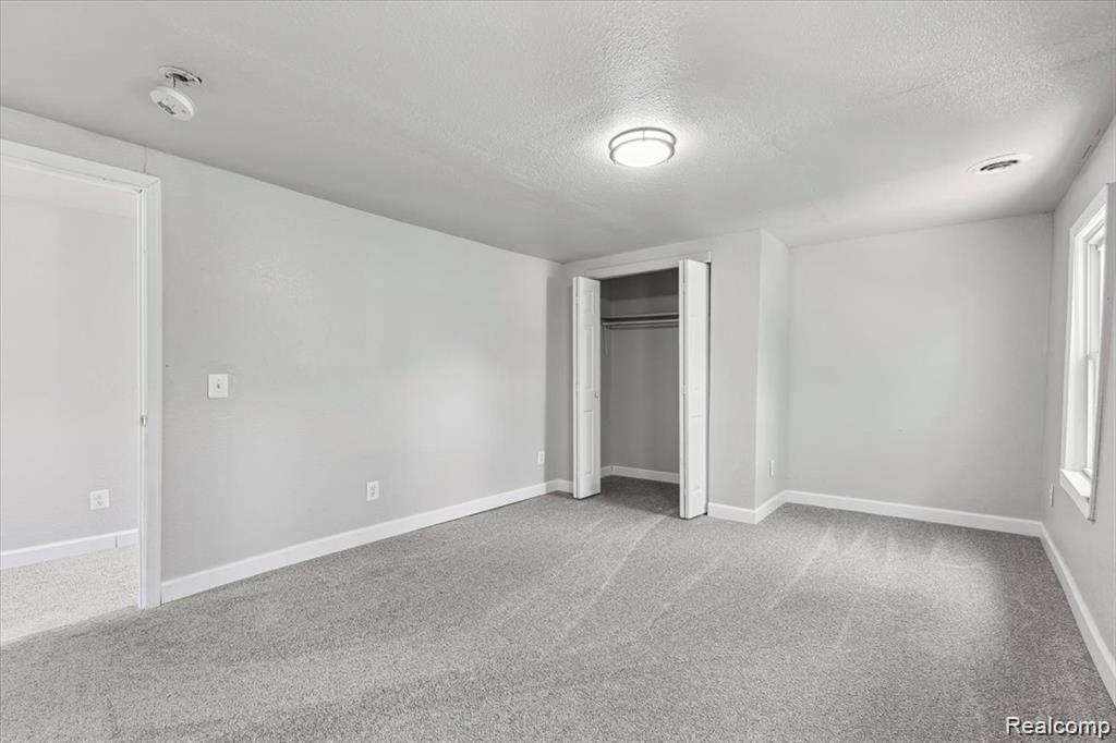 3140 Moore Street Inkster, MI 48141 - Photo 11 of 18 Light gray painted room featuring gray carpeting and white trim