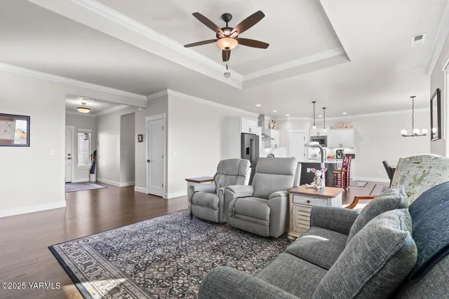 a kitchen with stainless steel appliances granite countertop a stove a refrigerator a kitchen island a dining table and chairs