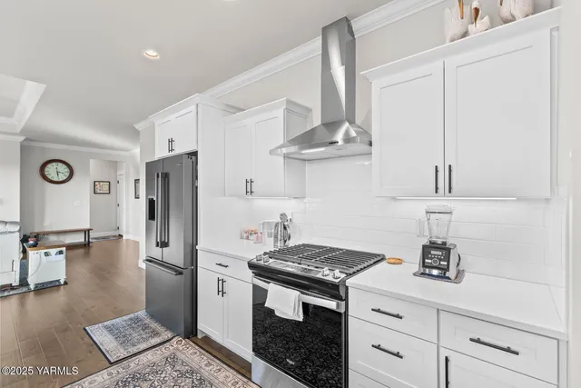 a large kitchen with a table and chairs