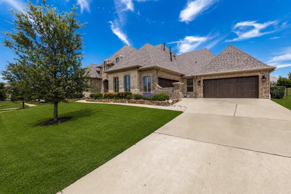 506 Life Spring Drive Rockwall, TX 75087 - Photo 2 of 36 a front view of a house with garden