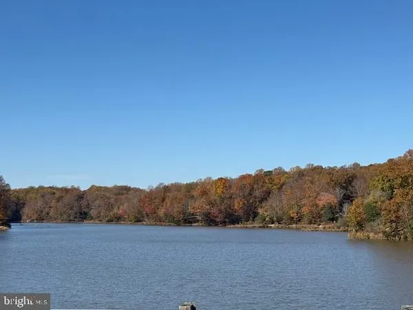an aerial view of residential houses with outdoor space and lake