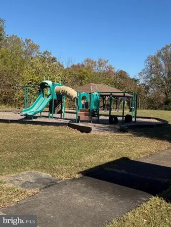 a view of wooden house with a yard