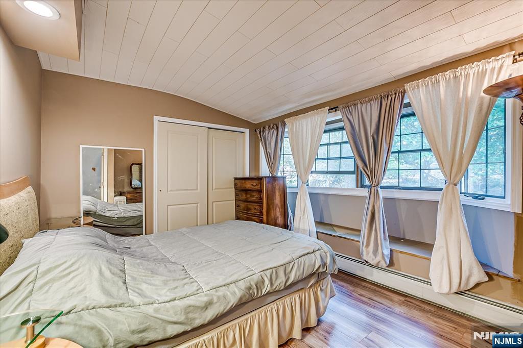 177 Otterhole Road West Milford, NJ 07480 - Photo 27 of 49 a bedroom with a large bed a flat tv screen and dresser