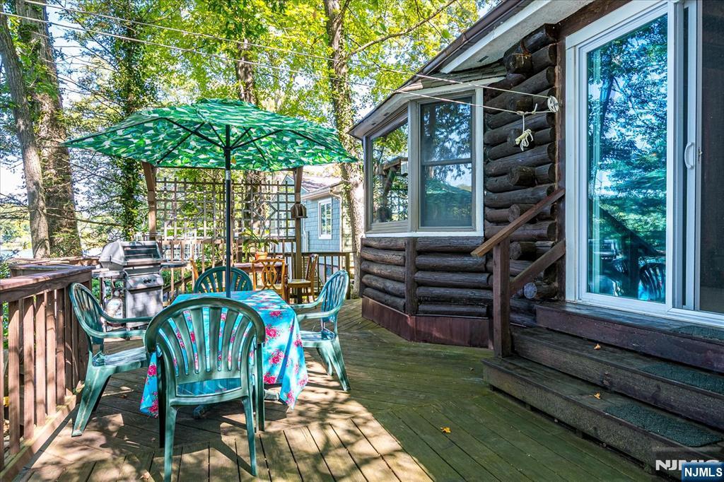 177 Otterhole Road West Milford, NJ 07480 - Photo 40 of 49 a view of a patio with a table chairs and a yard
