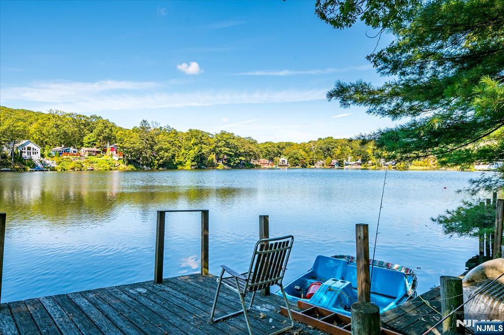177 Otterhole Road West Milford, NJ 07480 - Photo 43 of 49 a view of a lake with couches and wooden floor
