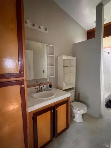 a view of staircase with lots of frames on wall and stairs