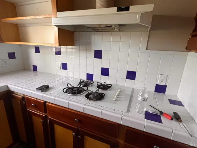 a bathroom with a granite countertop sink toilet and mirror