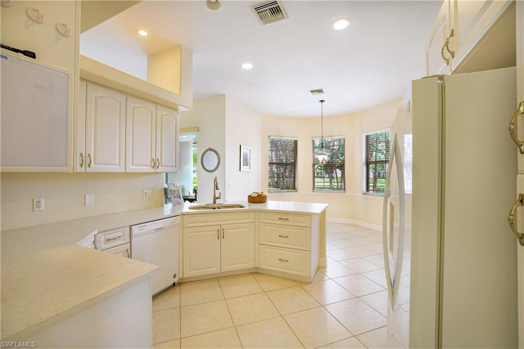 5235 Malvern Court Naples, FL 34112 - Photo 11 of 28 a large kitchen with stainless steel appliances lots of counter top space cabinets and a sink