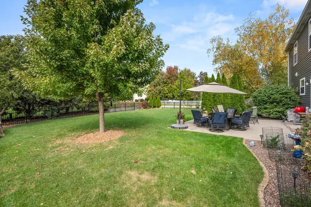 a view of patio with a table and chairs under an umbrella