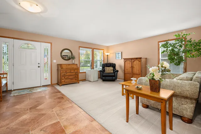 a living room with furniture and a lamp