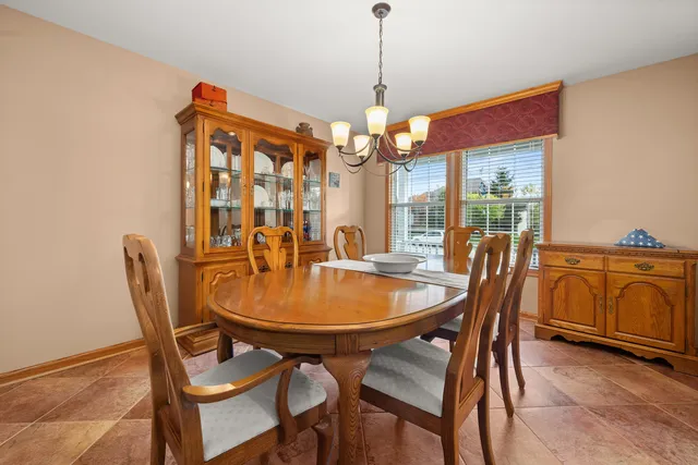 a living room with furniture a fireplace and a large window