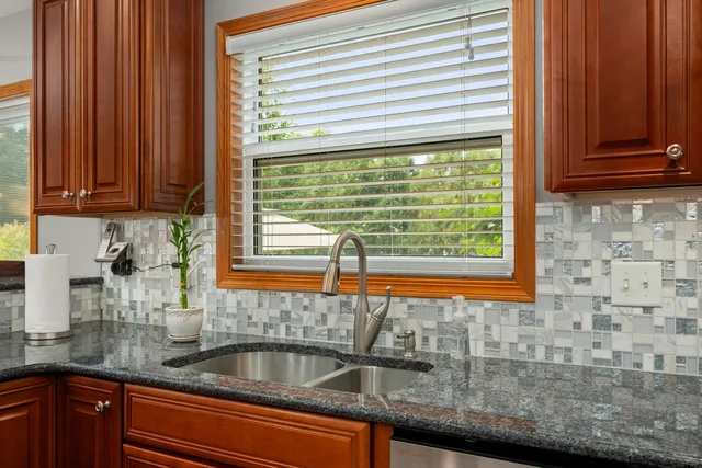 a dining room with furniture a chandelier and wooden floor