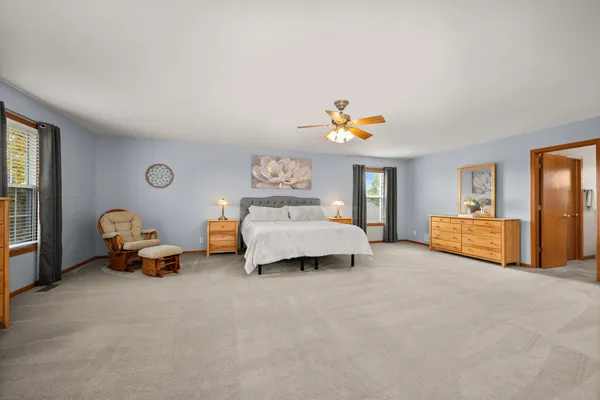 a spacious bedroom with a bed and a couch