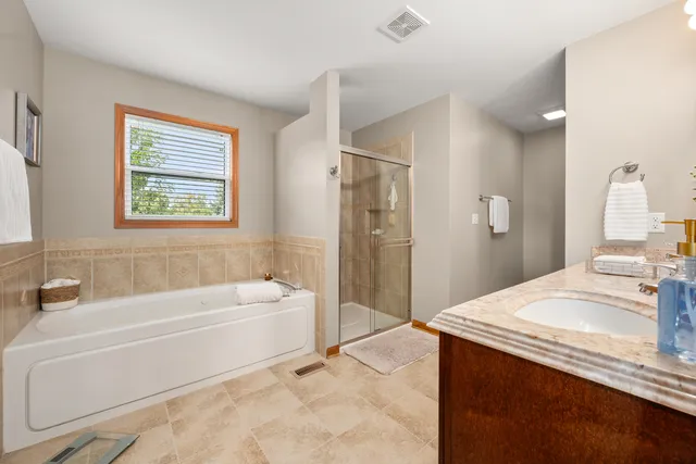 a spacious bathroom with a double vanity sink and a mirror
