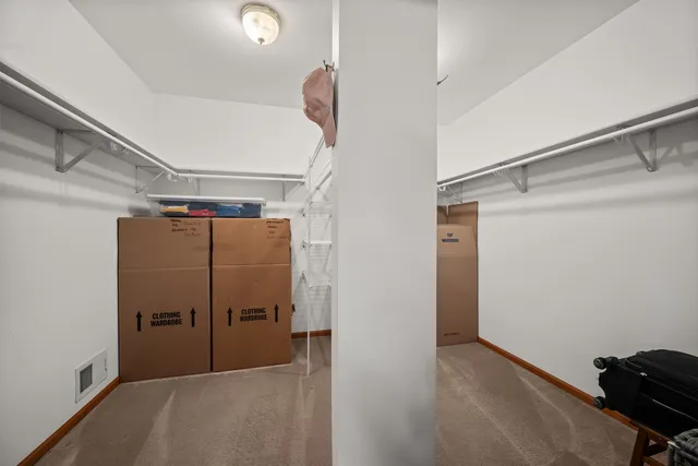 a bedroom with a bed dresser and a window