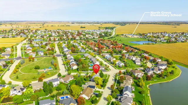 an aerial view of lake and residential houses with outdoor space