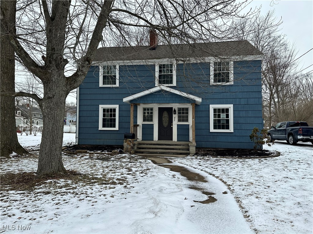 Colonial inspired home with a chimney