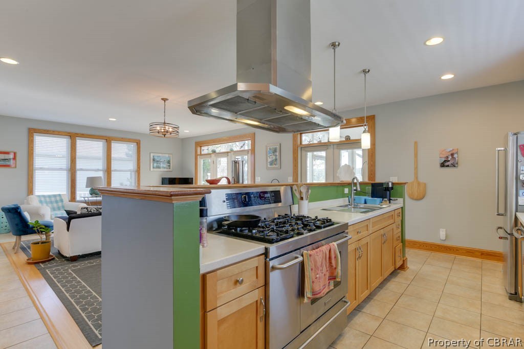 32 Riley's Way Hampton, VA 23664 - Photo 22 of 50 Kitchen with island exhaust hood, stainless steel range with gas stovetop, an island with sink, pendant lighting, and sink