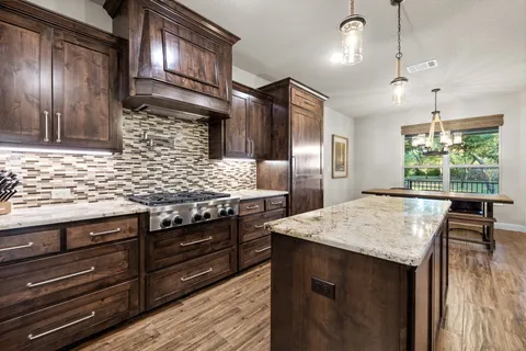 a living room with furniture a fireplace and a floor to ceiling window