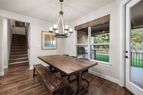 a kitchen with stainless steel appliances granite countertop a stove and a wooden floors