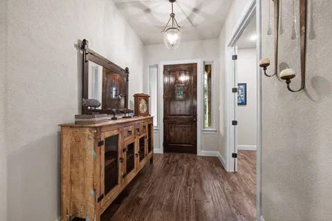 a bathroom with a granite countertop double vanity sink a mirror and a bathtub