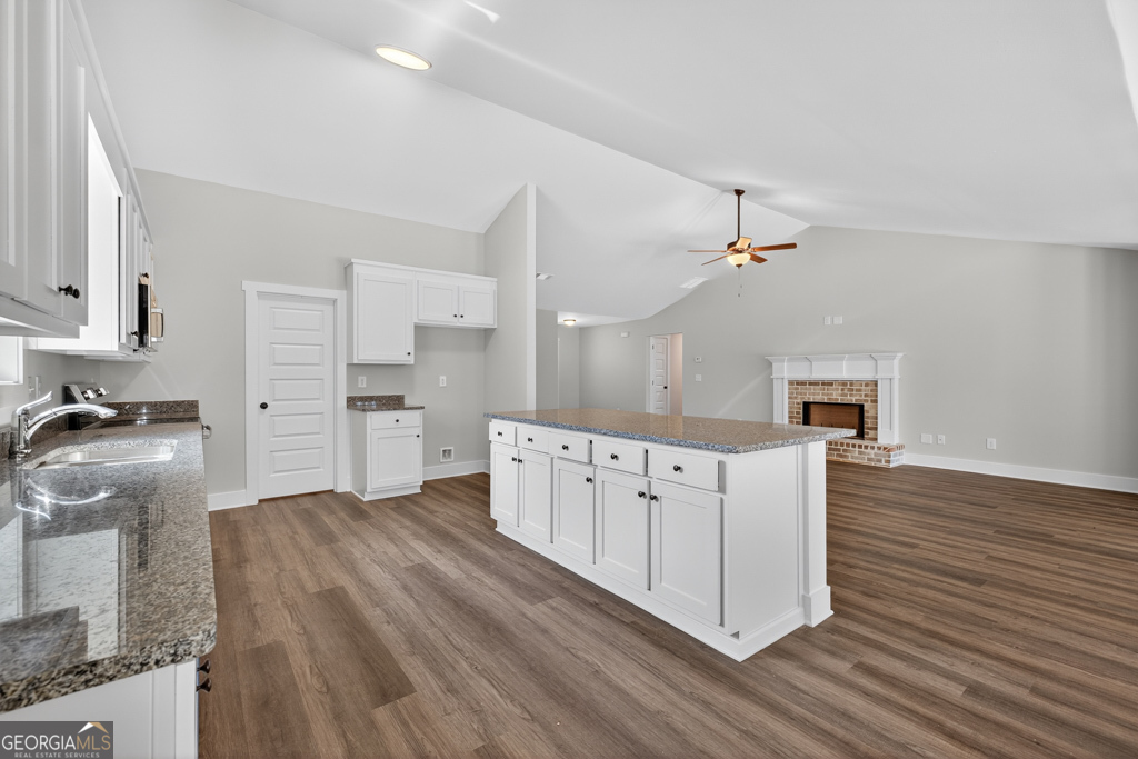 373 Liberty Hill Road, Unit 19 Hartwell, GA 30643 - Photo 11 of 31 a kitchen with stainless steel appliances cabinets a wooden floor and a sink