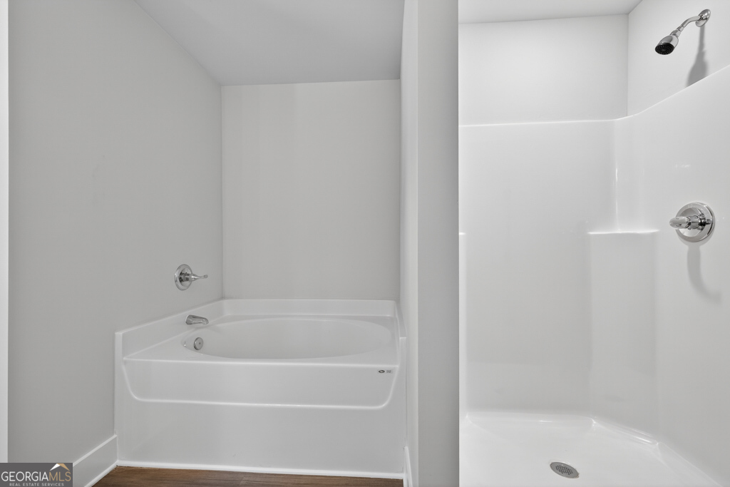 373 Liberty Hill Road, Unit 19 Hartwell, GA 30643 - Photo 24 of 31 a white bath tub sitting next to a shower