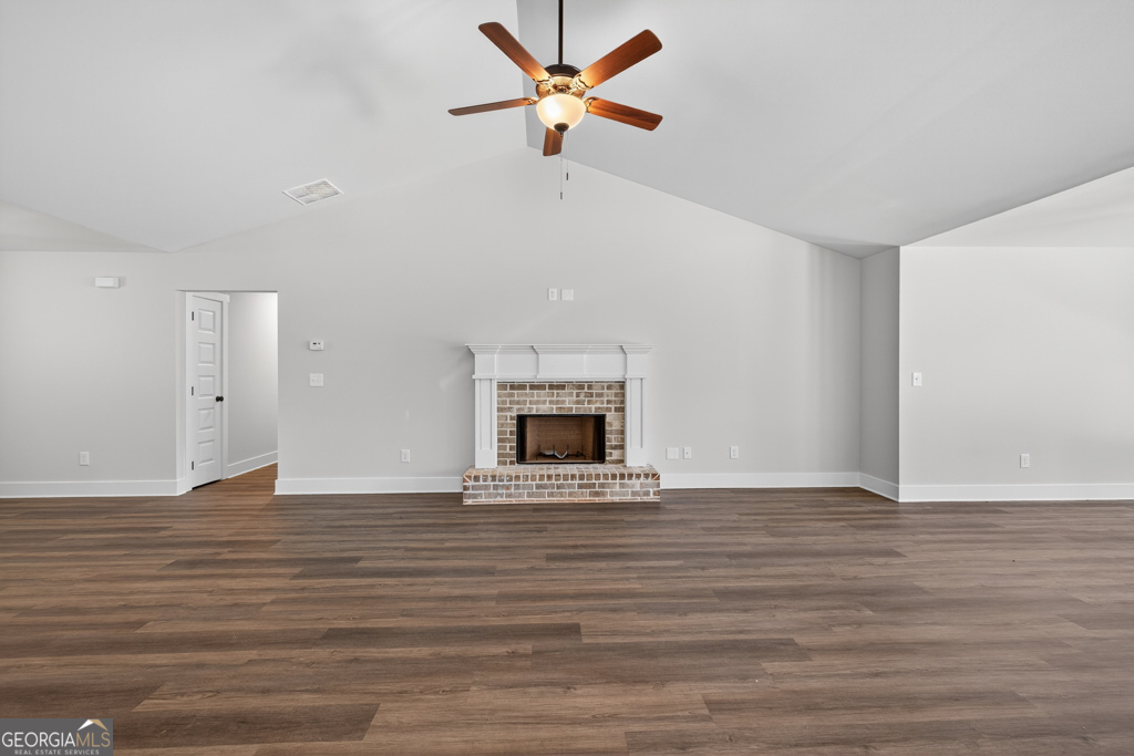 373 Liberty Hill Road, Unit 19 Hartwell, GA 30643 - Photo 6 of 31 a view of an empty room with a fireplace and a chandelier fan