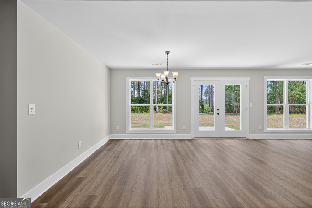 373 Liberty Hill Road, Unit 19 Hartwell, GA 30643 - Photo 7 of 31 a view of an empty room with wooden floor and a window